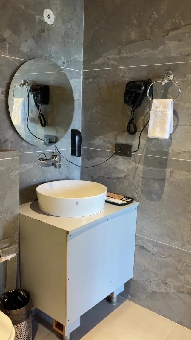 Modern Bathroom Interior with White Vessel Sink and Grey Marble Walls