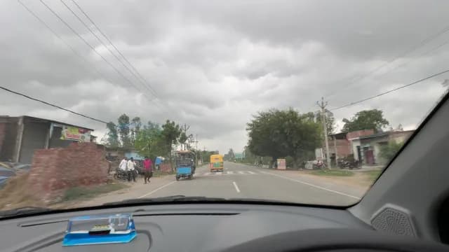 Driving on a Rural Indian Highway Under Cloudy Skies