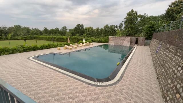 Luxury Outdoor Swimming Pool at Tropical Resort with Sunbeds