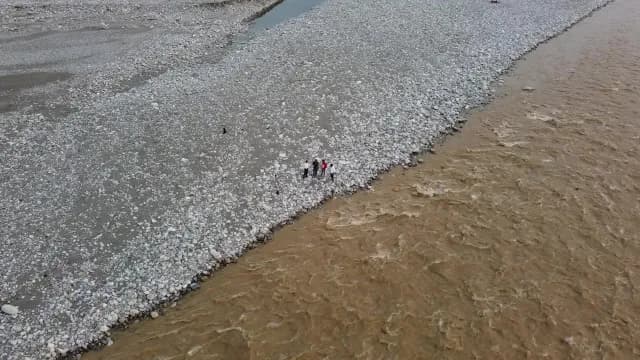 Aerial View of People Standing by a Fast Flowing Muddy Kosi River, Ramnagar, Uttarakhand