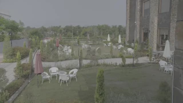 Peaceful Garden Patio with White Tables and Chairs at a Resort
