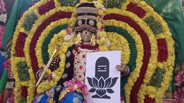 Elaborately Decorated Hindu Goddess Statue with Vibrant Flower Backdrop, Navarathiri Festival